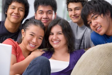 Multi ethnic students pose together clipart