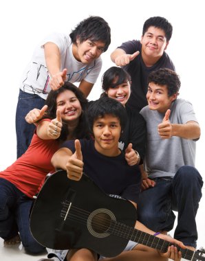 Group of multi ethnic teenagers posing together clipart