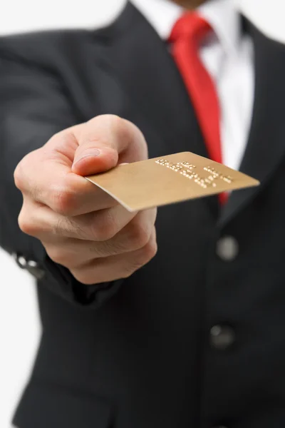 Businessman giving gold credit card — Stock Photo, Image