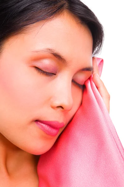 Young woman touching smooth satin with her face (close up) — Stock Photo, Image