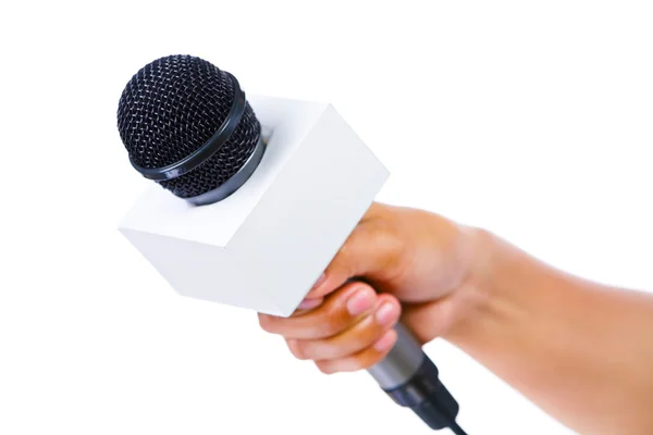 Bare hand holding microphone — Stock Photo, Image