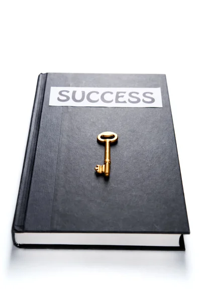 Golden key on success book — Stock Photo, Image