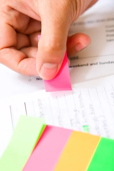Placing colorful tag on book — Stock Photo, Image