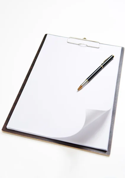 Curled page on clipboard — Stock Photo, Image