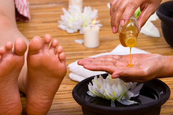 Pouring massage oil — Stock Photo, Image