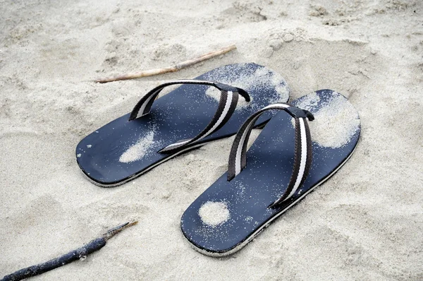 stock image Flip flops in sand