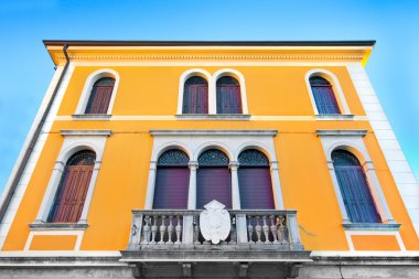 Yellow house against blue sky clipart