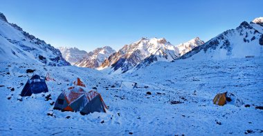 Mountain camp in the Himalayas at sunrise clipart