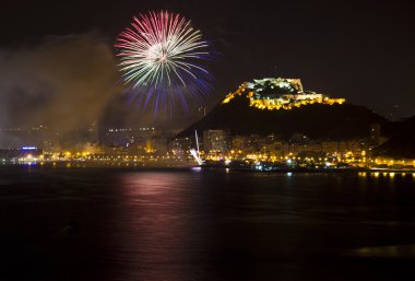 Alicante City by Night with Blue Green and Red Fireworks clipart