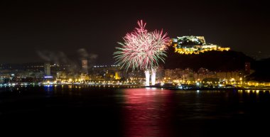 Alicante City by Night with Red and Green Star Fireworks clipart