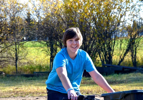 Male teen riding a quad in the fall. — Stock Photo, Image