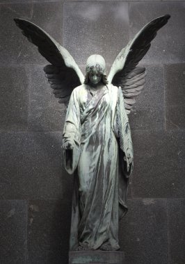 Sculpture of an angel with dark background