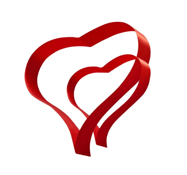 Röda bandet närvarande gåva hjärtan isolerade — Stockfoto