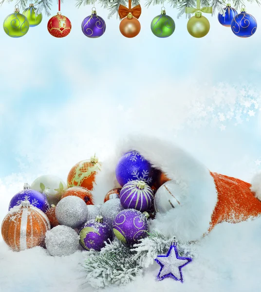 Christmas santa claus hat baubles and snow concept — Stock Photo, Image