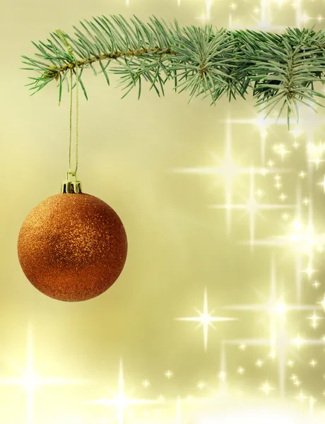 Christmas red bauble on green tree on golden background — Stock Photo, Image