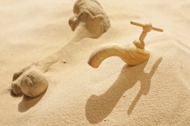 Global warming climate change faucet in the sand