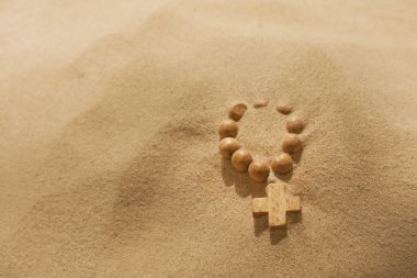 Losing faith rosary on desert religion symbol metaphor clipart