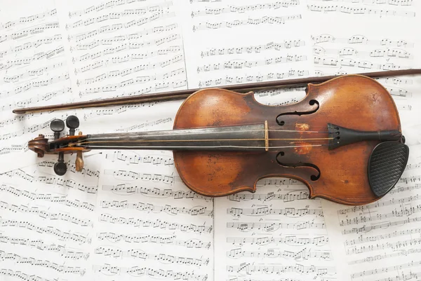 stock image An old violin with a bow on the background music