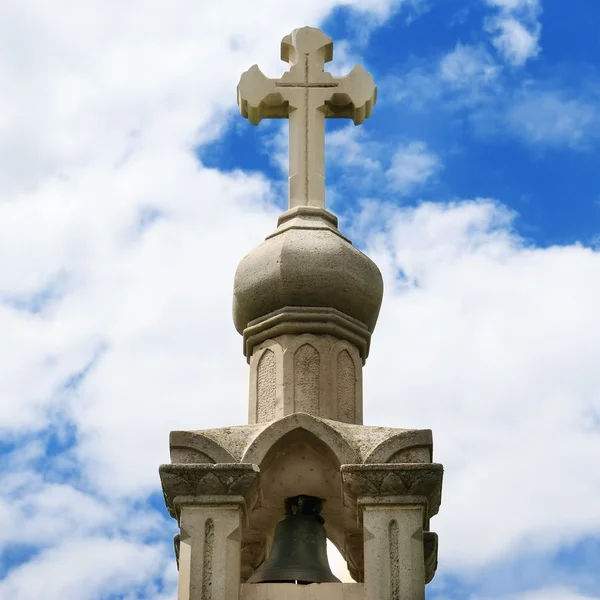 stock image Stone cross on blue sky background