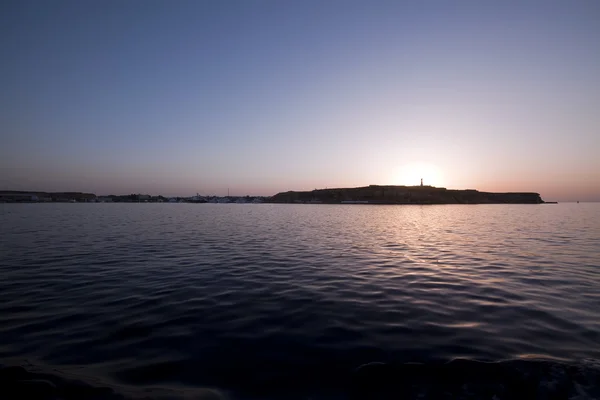 stock image Leaving the harbour at sunset.