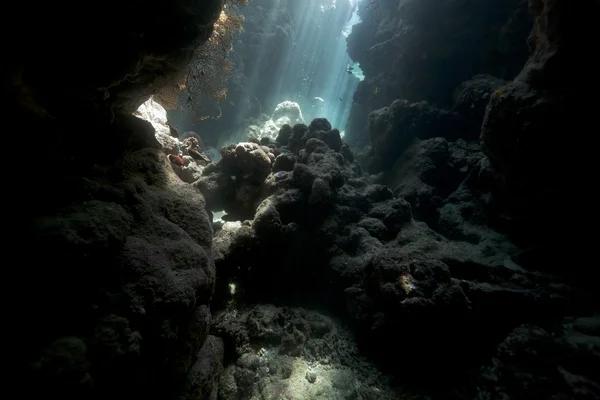 Underwater cave and sunrays in the Red Sea. Stock Image