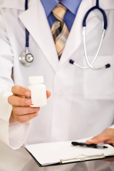 Doctor's hand holding medicine — Stock Photo, Image