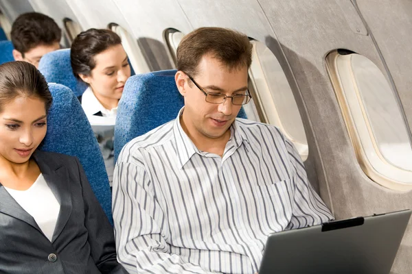 Working in airplane — Stock Photo, Image