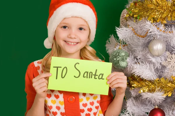 Menina feliz segurando carta com nota 'Para o Pai Natal' — Fotografia de Stock