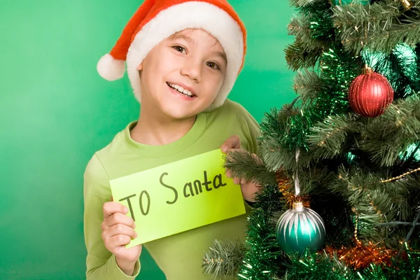 Feliz rapaz segurando carta com nota 'Para o Pai Natal' — Fotografia de Stock