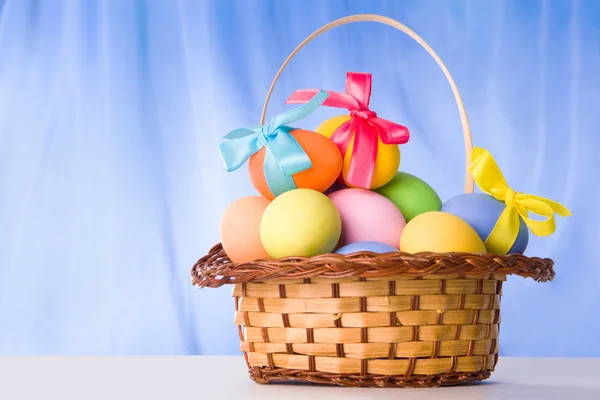 Basket with colorful eggs — Stock Photo, Image