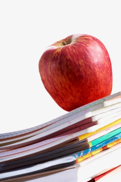 Red apple on copybooks — Stock Photo, Image