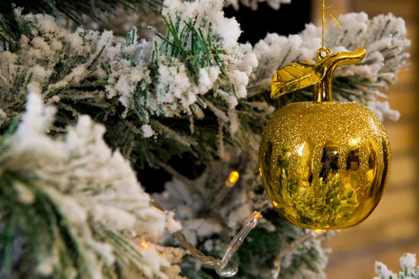 Golden apple on Christmas tree — Stock Photo, Image