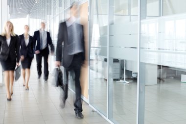 Businesspeople in corridor clipart