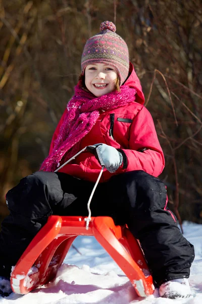 Girl on sledge — Stock Photo, Image