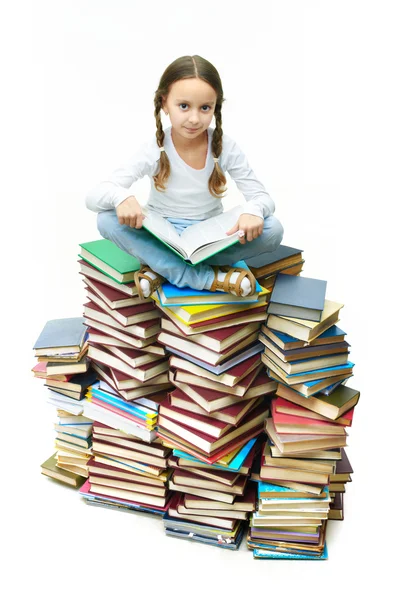 Meisje op boeken — Stockfoto
