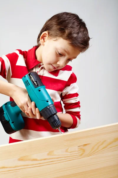 Boy drilling — Stock Photo, Image