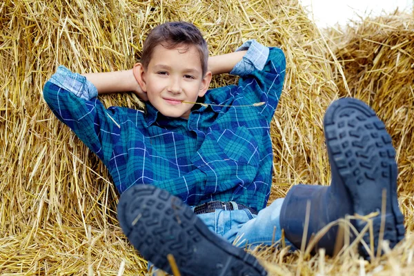 Boy on hay — Stock Photo, Image