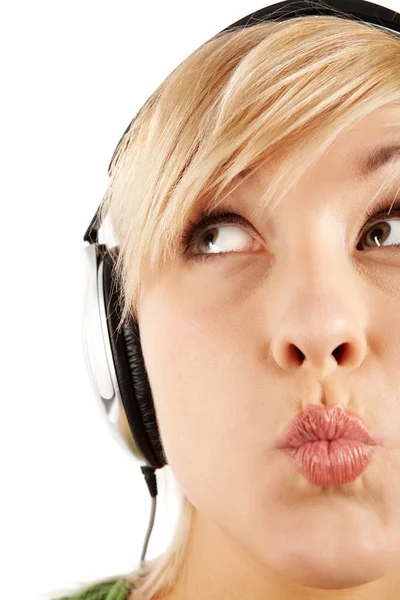 Close-up of a careful girl's face in headphones — Stock Photo, Image