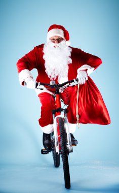 Santa on bicycle clipart