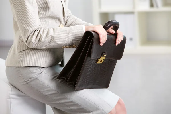 Briefcase in hands — Stock Photo, Image