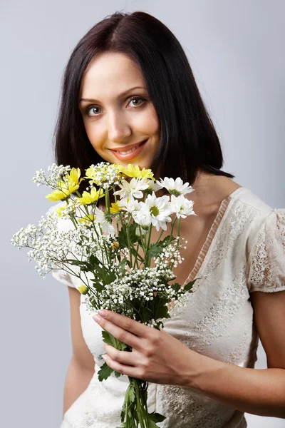 Brunette with flowers — Stock Photo, Image