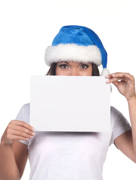 Woman in blue santa hat holding empty board — Stock Photo, Image