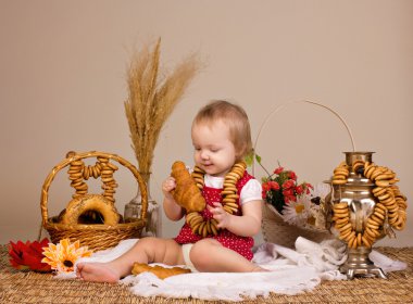 Little girl eating croissant clipart