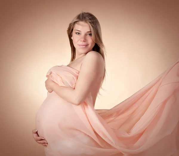 Beautiful pregnant woman in light cloth — Stock Photo, Image