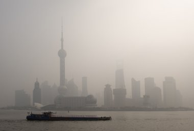 Air pollution over Shanghai, a barge is passing clipart