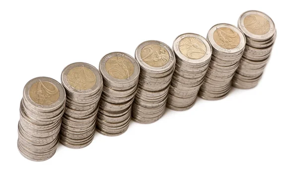 Stacks of 2 Euros Coins in front of white background, high angle view — Stock Photo, Image