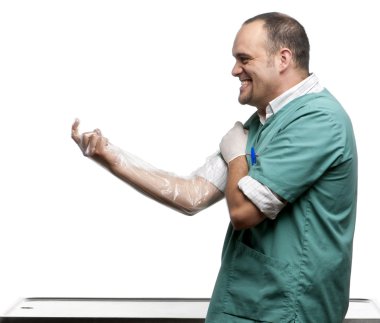 Vet putting on a plastic glove in front of white background clipart