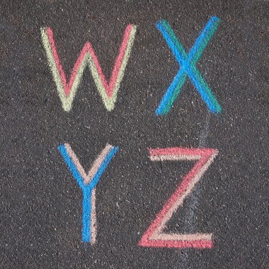 Alphabet letters drawn on asphalt with chalk, w, x, y, z clipart