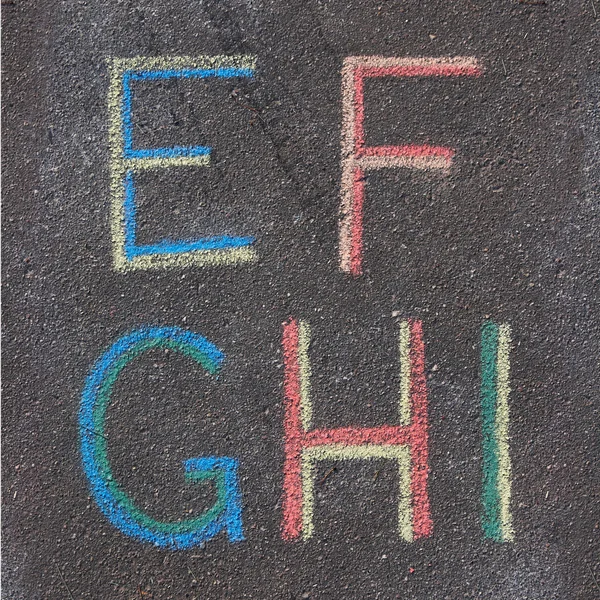 Alphabet letters drawn on asphalt with chalk, e, f, g, h, i — Stock Photo, Image