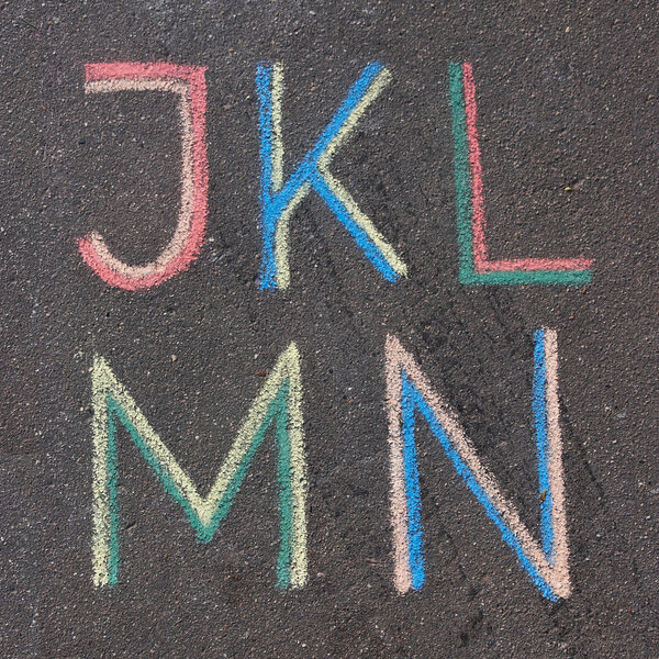 Alphabet letters drawn on asphalt with chalk, j, k, l, m, n